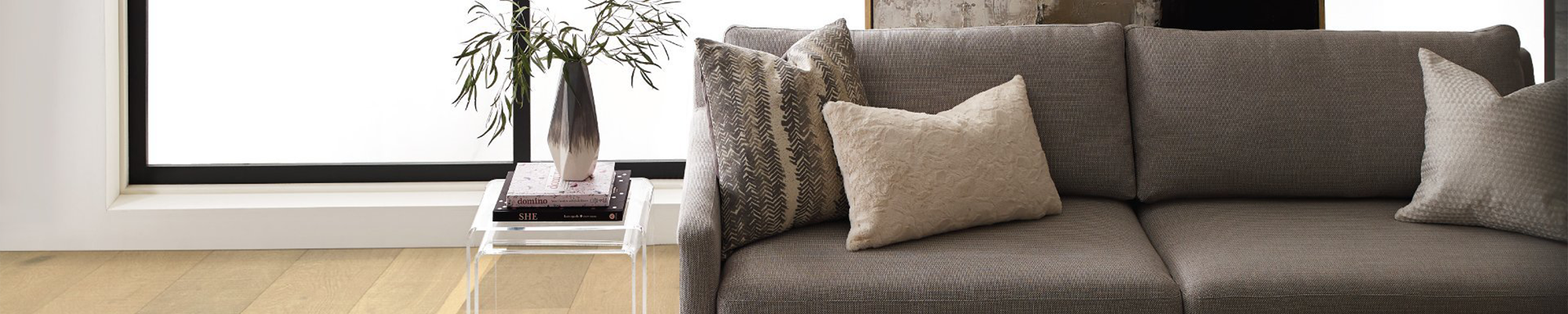 beige couch in living room with side table