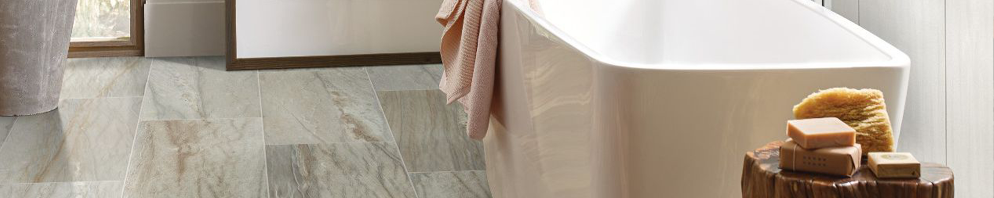 bathtub and stool with soap on tile floor
